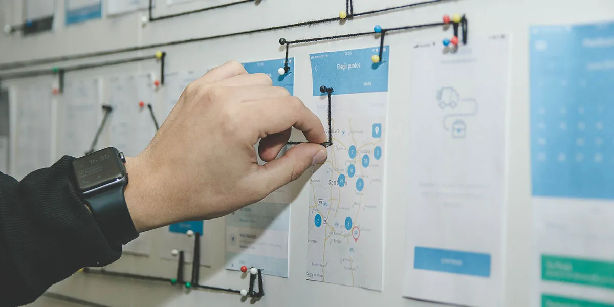 photo of hand connecting pegs on a board with a string
